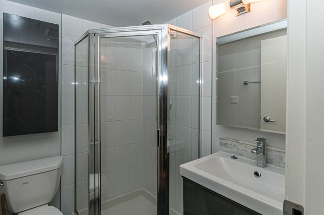Bright bathroom with modern fixtures and a corner shower. - 505 - 822 Homer Street, Vancouver Downtown