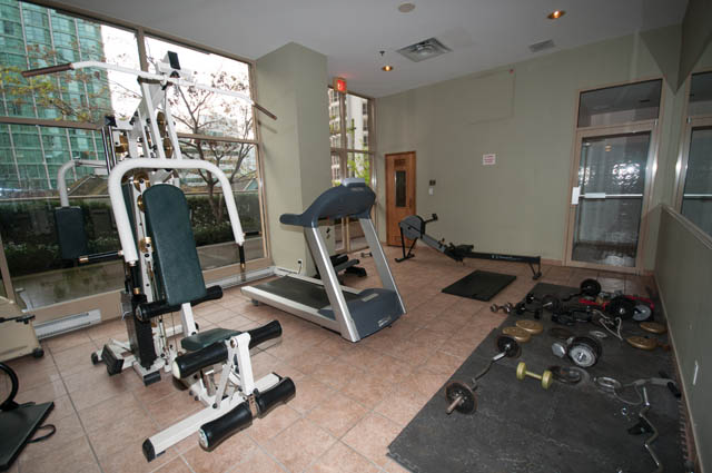 Bright and spacious gym with large windows, city view, and modern equipment. - 505 - 822 Homer Street, Vancouver Downtown