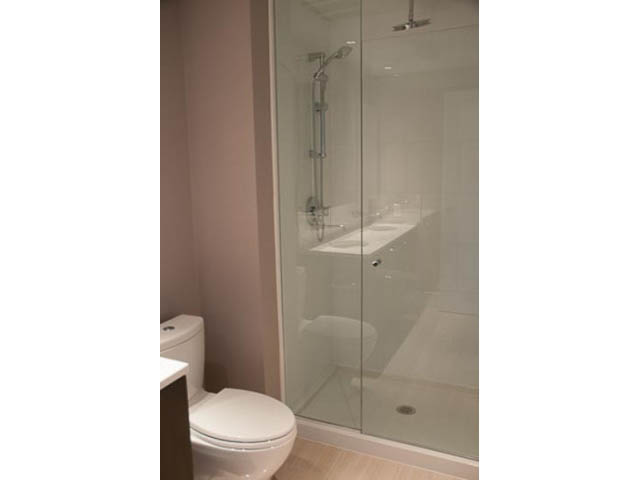 Furnished bathroom with glass shower and white fixtures. - 407-150 West 15th Street, North Vancouver