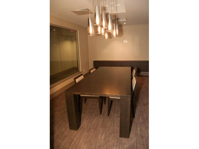 Modern dining area with sleek table and contemporary lighting. - 407-150 West 15th Street, North Vancouver