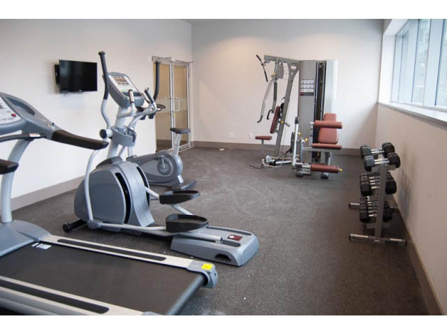 Fitness room with treadmills, elliptical, and dumbbells. - 407-150 West 15th Street, North Vancouver