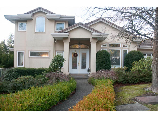 Furnished 4-bedroom + den house with a welcoming front entrance and lush landscaping. - 4287 Madeley Rd, North Vancouver