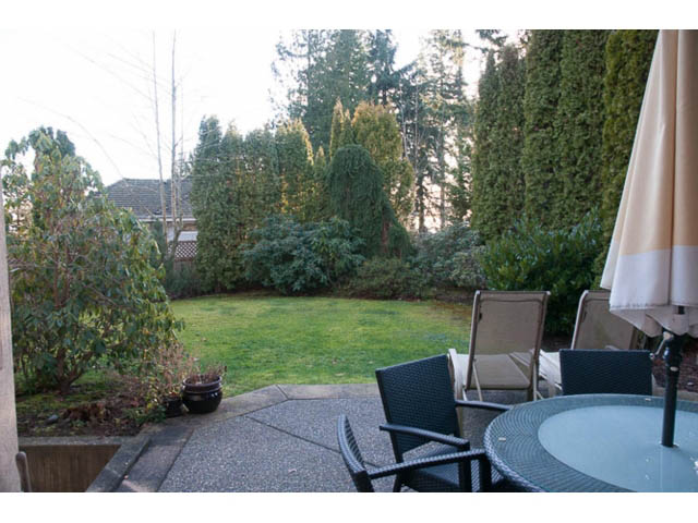 Furnished patio with outdoor seating and lush greenery. - 4287 Madeley Rd, North Vancouver