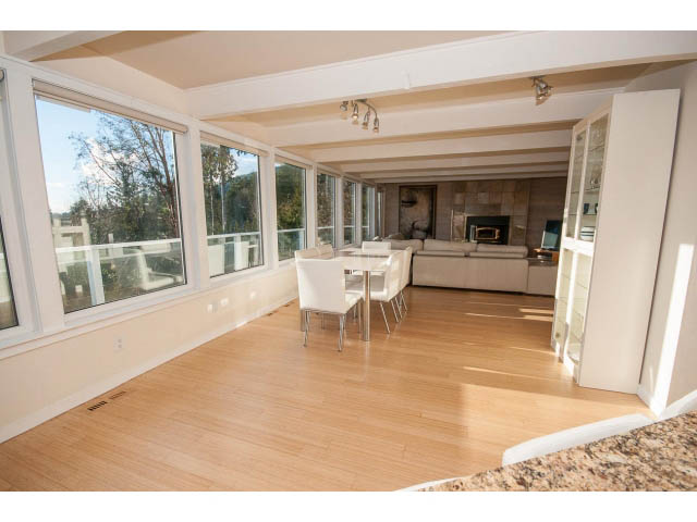 Spacious living room with hardwood floors, large windows, and city view. - 2720 Rosebery Avenue, West Vancouver