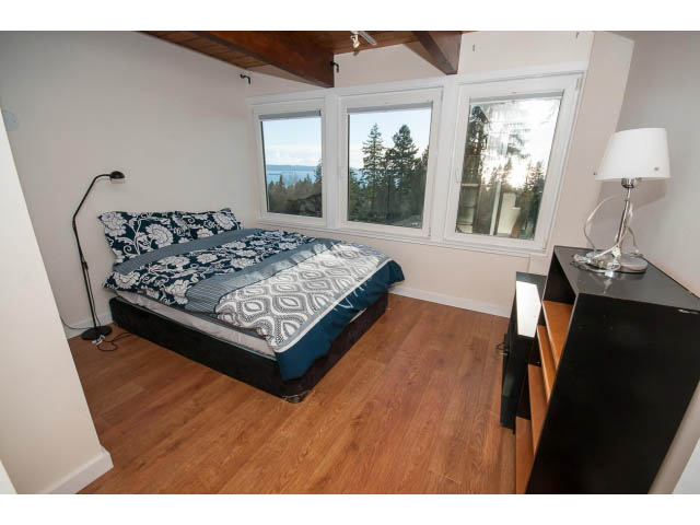 Bright bedroom with hardwood floors, large windows, and a view of the lake. - 2720 Rosebery Avenue, West Vancouver