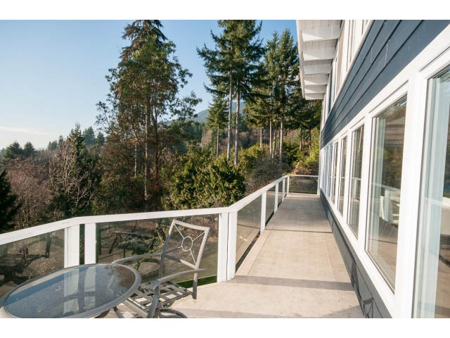 Furnished balcony with glass table and chairs, overlooking forest. - 2720 Rosebery Avenue, West Vancouver