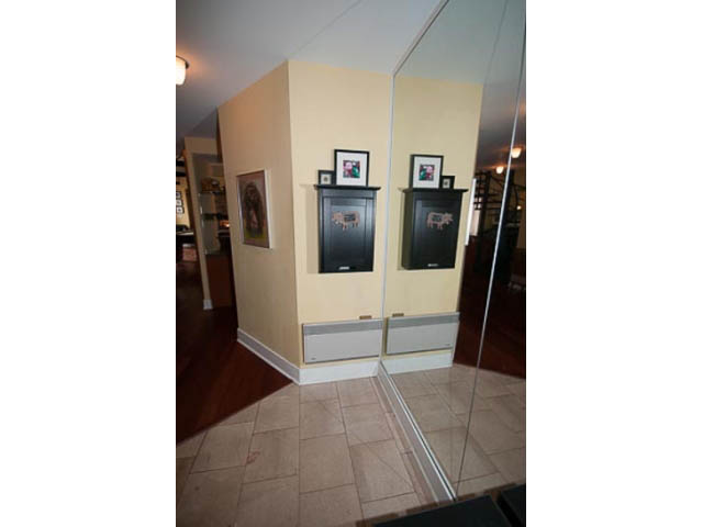 Living room with mirrored wall, hardwood floors, and framed artwork. - 705 - 1263 Barclay, Vancouver Downtown