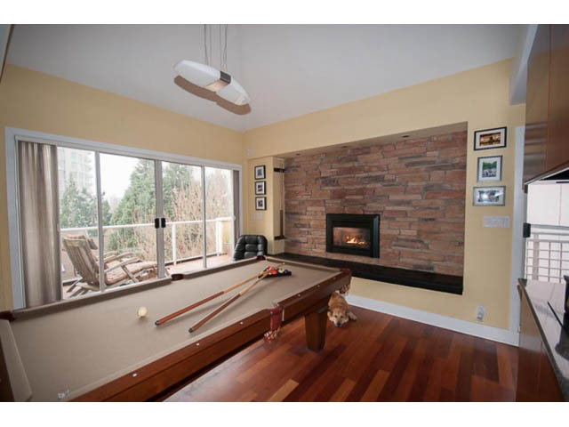 Bright living room with hardwood floors, city view, and a cozy fireplace. - 705 - 1263 Barclay, Vancouver Downtown