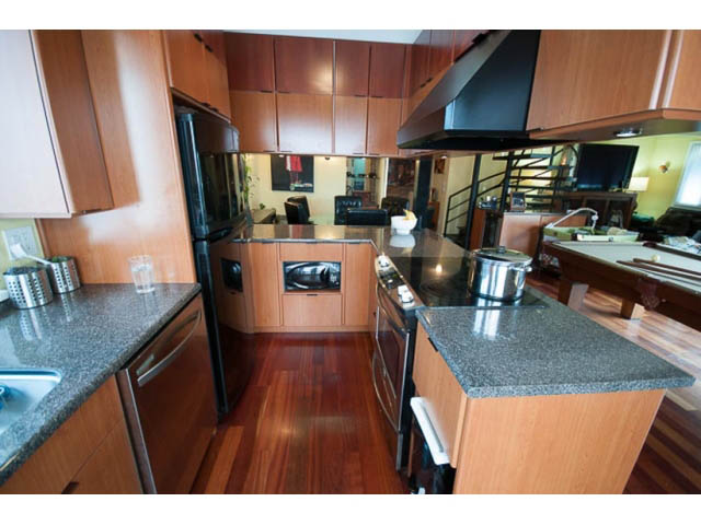 Bright kitchen with granite countertops, hardwood floors, and a modern stove. - 705 - 1263 Barclay, Vancouver Downtown