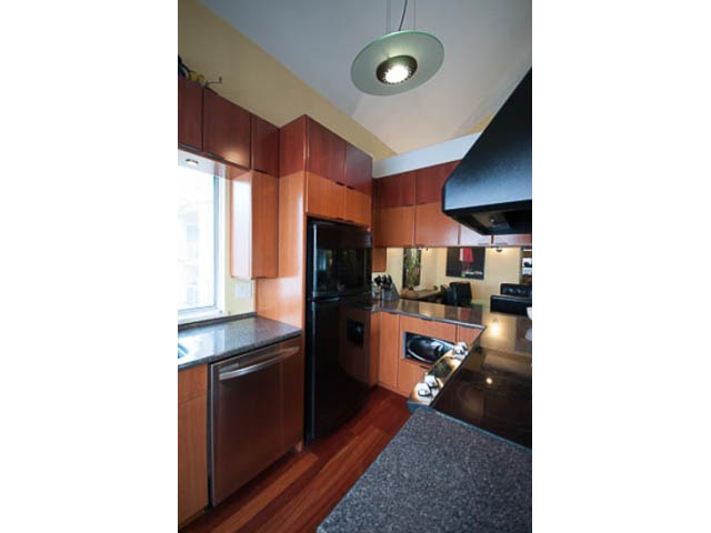 Bright kitchen with dark countertops, hardwood floors, and a modern light fixture. - 705 - 1263 Barclay, Vancouver Downtown