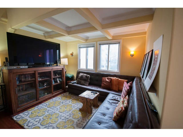 Spacious living room with large TV, hardwood floors, and cozy seating. - 705 - 1263 Barclay, Vancouver Downtown