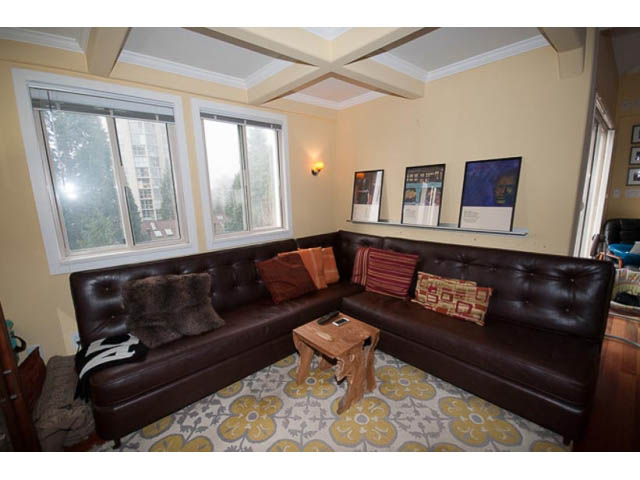 Bright living room with large windows, leather sofas, and patterned rug. - 705 - 1263 Barclay, Vancouver Downtown
