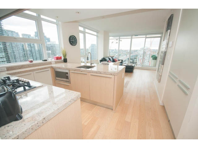 Bright kitchen with granite countertops, hardwood floors, and a city view. - 1707 - 1351 Continental St, Vancouver Downtown