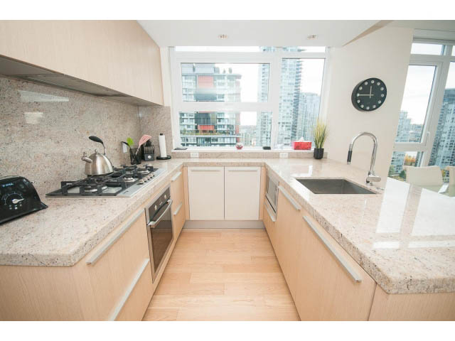 Bright kitchen with granite countertops, hardwood floors, and a city view. - 1707 - 1351 Continental St, Vancouver Downtown