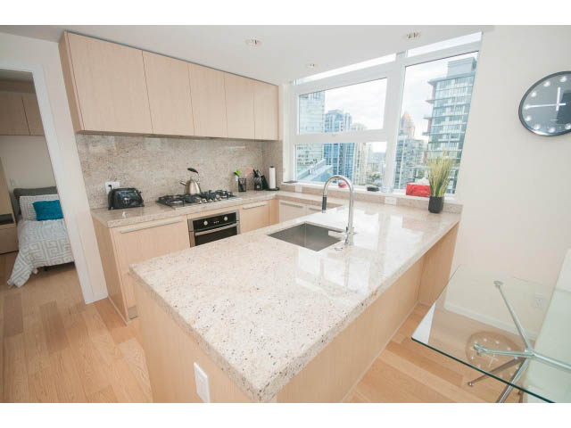 Bright kitchen with granite countertops, hardwood floors, and a city view. - 1707 - 1351 Continental St, Vancouver Downtown