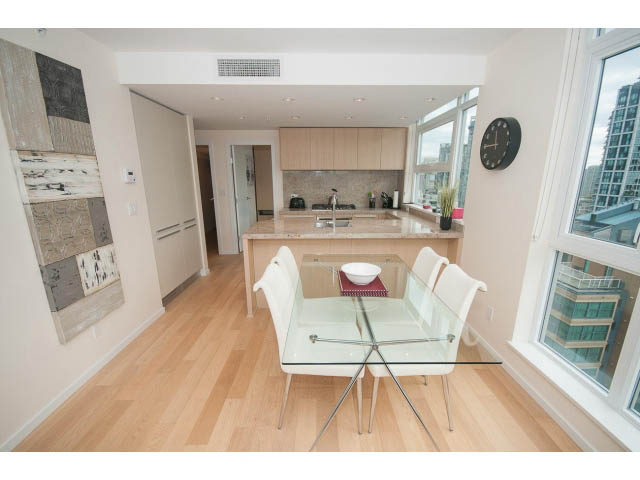 Bright dining area with hardwood floors, city view, and modern furnishings. - 1707 - 1351 Continental St, Vancouver Downtown