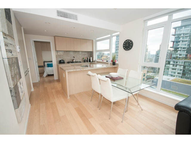 Bright dining area with hardwood floors, city view, and modern furnishings. - 1707 - 1351 Continental St, Vancouver Downtown