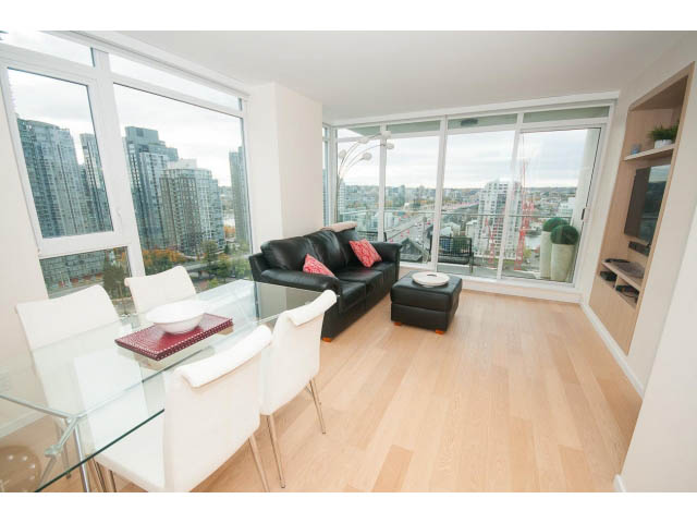 Bright living room with hardwood floors, city view, and modern furnishings. - 1707 - 1351 Continental St, Vancouver Downtown