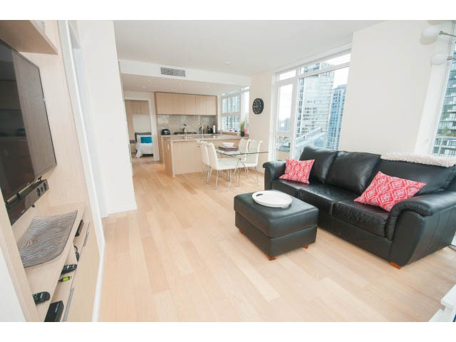 Bright living room with hardwood floors, city view, and modern furnishings. - 1707 - 1351 Continental St, Vancouver Downtown