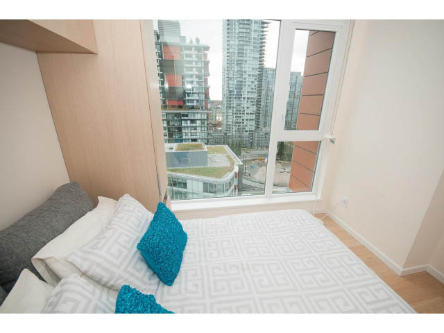 Furnished bedroom with city view and modern decor. - 1707 - 1351 Continental St, Vancouver Downtown
