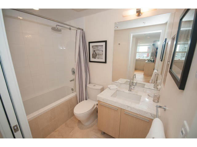 Furnished bathroom with marble countertops and a large mirror. - 1707 - 1351 Continental St, Vancouver Downtown