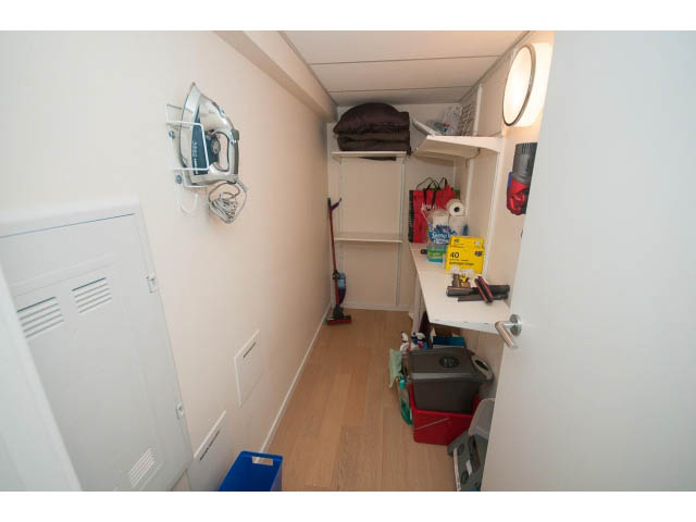 Bright laundry room with hardwood floors, iron and shelves. - 1707 - 1351 Continental St, Vancouver Downtown