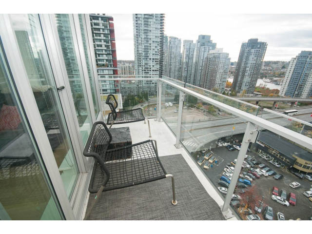 Furnished balcony with city view and modern furniture. - 1707 - 1351 Continental St, Vancouver Downtown