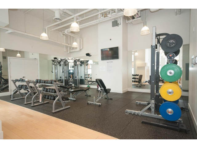 Bright and modern gym with hardwood floors and large mirrors. - 1707 - 1351 Continental St, Vancouver Downtown