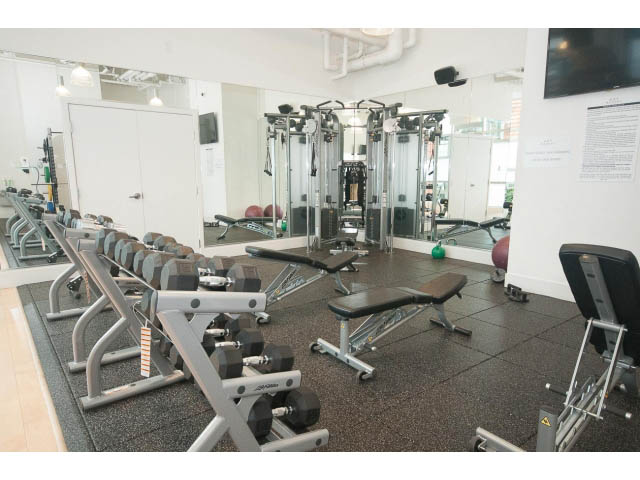 Fitness room with weight machines and dumbbells. - 1707 - 1351 Continental St, Vancouver Downtown
