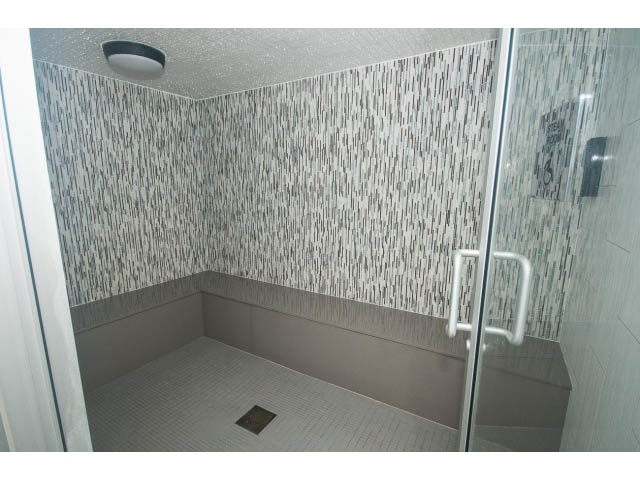 Spacious, modern shower with mosaic tile walls and glass doors. - 1707 - 1351 Continental St, Vancouver Downtown