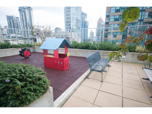Furnished rooftop patio with city view, red playhouse, and modern furniture. - 1707 - 1351 Continental St, Vancouver Downtown