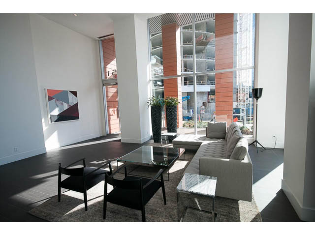 Bright living room with modern furniture, city view, and large windows. - 1707 - 1351 Continental St, Vancouver Downtown