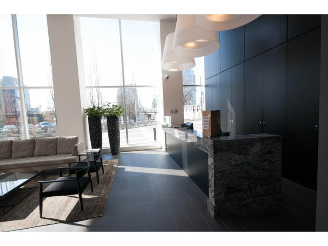 Furnished living room with city view and modern lighting. - 1707 - 1351 Continental St, Vancouver Downtown