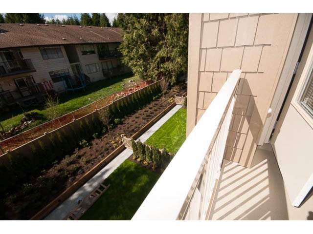 Bright balcony with greenery and city view. - 309 - 2665 Mountain Hwy, North Vancouver