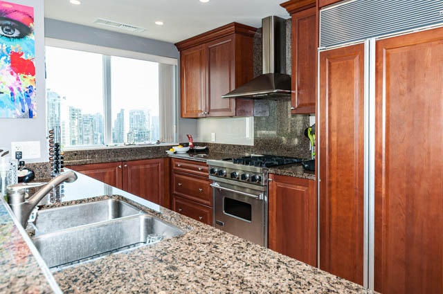 Bright kitchen with granite countertops, wooden cabinets, and a city view. - 2503 - 428 Beach Crescent, Vancouver Downtown