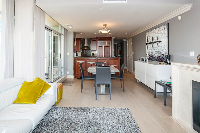 Furnished living room with white couch, yellow throw pillows, and hardwood floors. - 2503 - 428 Beach Crescent, Vancouver Downtown