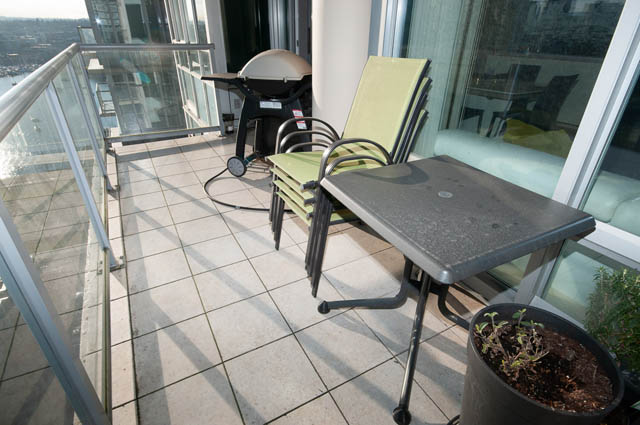 Furnished balcony with tiled flooring, outdoor furniture, and city view. - 2503 - 428 Beach Crescent, Vancouver Downtown