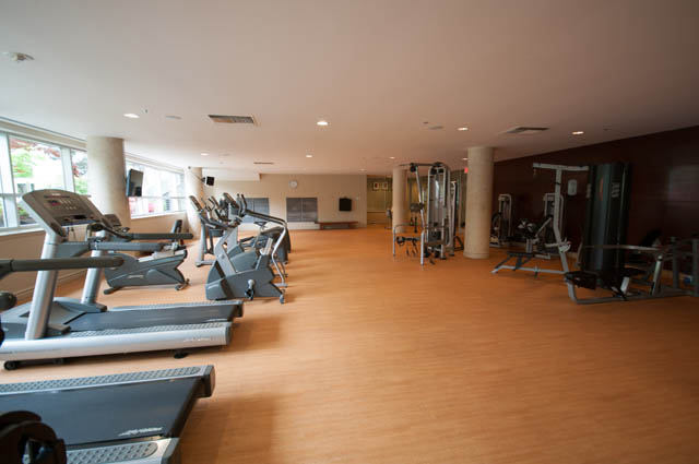 Spacious gym with hardwood floors, cardio machines, and weight equipment. - 2503 - 428 Beach Crescent, Vancouver Downtown