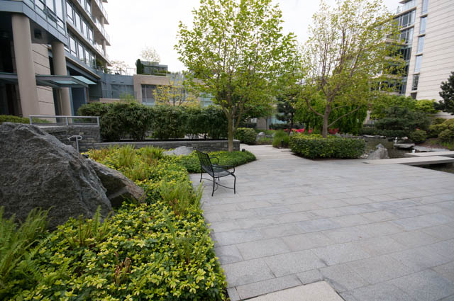 Furnished patio with stone seating and lush greenery. - 2503 - 428 Beach Crescent, Vancouver Downtown