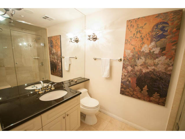 Spacious bathroom with dark countertops, wall art, and a large mirror. - 1102 - 1777  Bayshore Drive, Vancouver Downtown