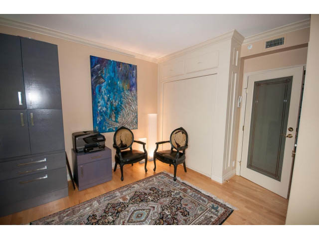 Bright living room with hardwood floors, a patterned rug, and a large abstract painting. - 1102 - 1777  Bayshore Drive, Vancouver Downtown