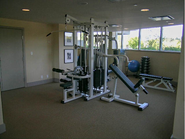 Bright gym with exercise equipment and large windows. - 1102 - 1777  Bayshore Drive, Vancouver Downtown