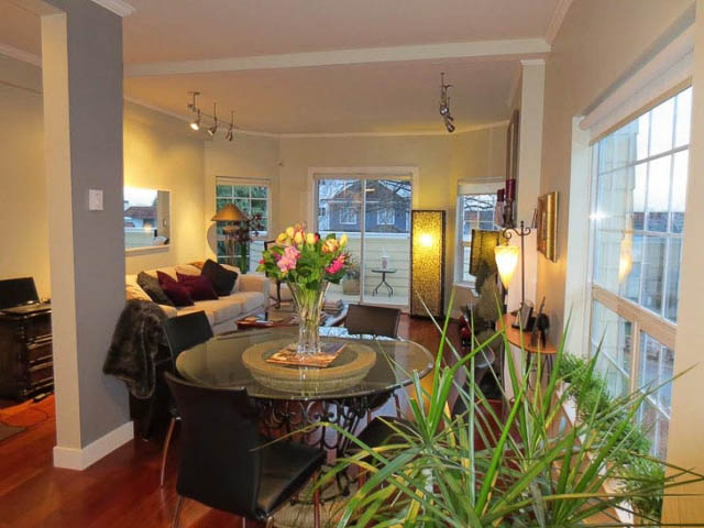 Bright living room with hardwood floors, large windows, and a cozy sofa setup. - 2158 West 3rd Ave, Vancouver West Side
