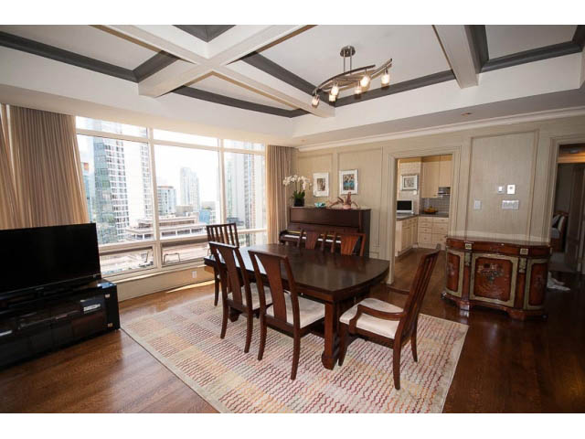 Furnished dining area with hardwood floors, city view, and coffered ceiling. - 9A - 1500 Alberni St, Vancouver Downtown