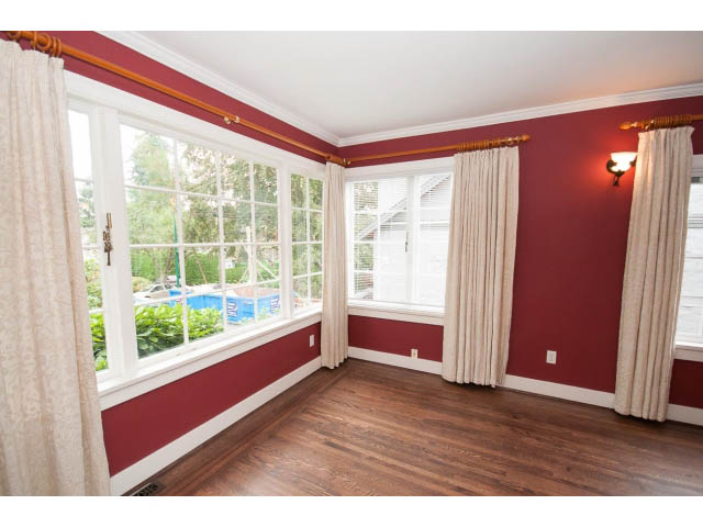Bright sunroom with hardwood floors and city view. - 3407 West 34th Ave, Vancouver West Side