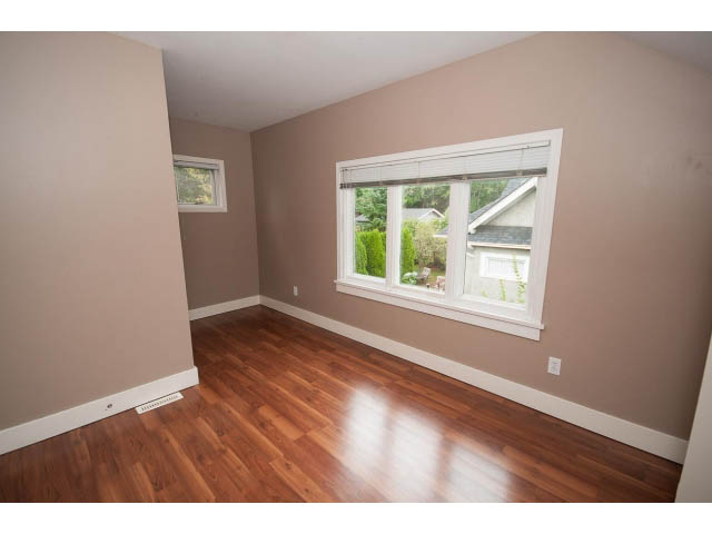 Spacious living room with hardwood floors and large windows. - 3407 West 34th Ave, Vancouver West Side