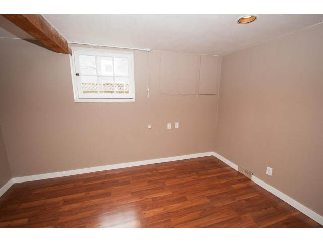 Empty living room with hardwood floors and a window with a view. - 3407 West 34th Ave, Vancouver West Side