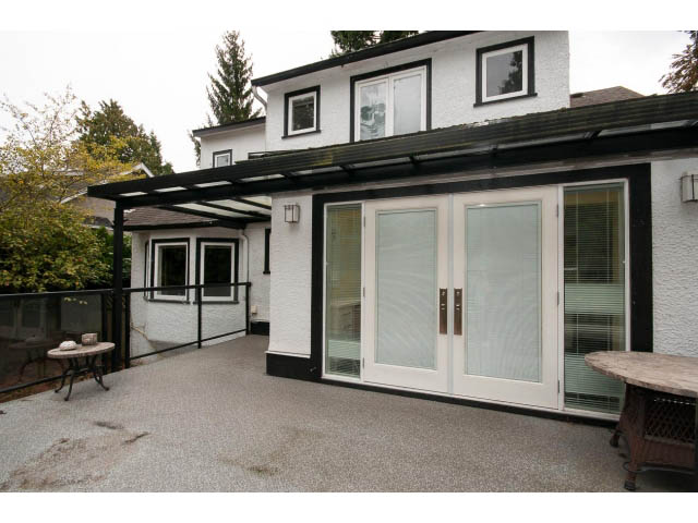 Furnished patio with glass doors, modern design, and a covered awning. - 3407 West 34th Ave, Vancouver West Side