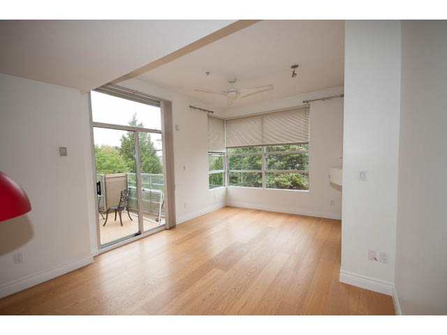 Spacious living room with hardwood floors and large windows offering a city view. - 409 - 3023 West 4th Ave., Vancouver West Side