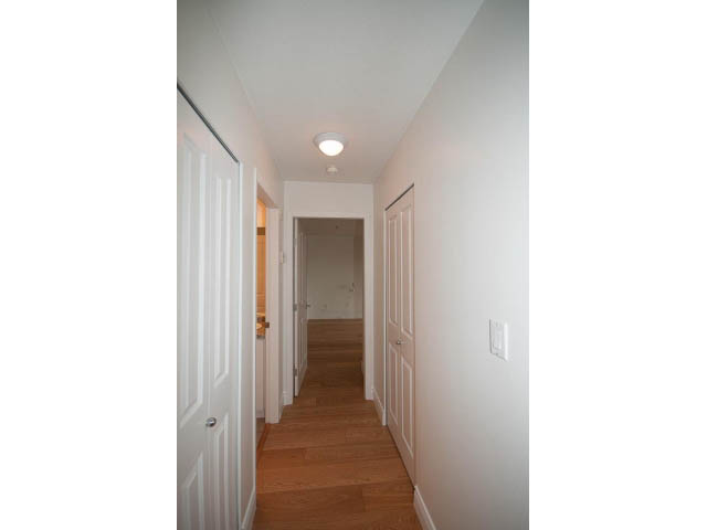 Furnished hallway with hardwood floors and white walls leading to a den. - 409 - 3023 West 4th Ave., Vancouver West Side